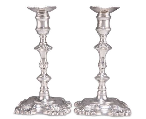 A PAIR OF GEORGE II SILVER CANDLESTICKS by William Gould, London 1750, each with a knopped stem issuing from a shaped square 