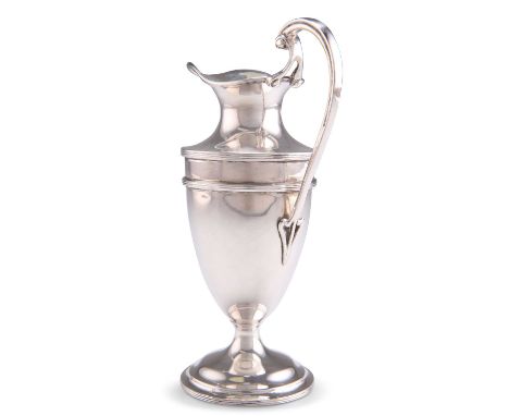 A GEORGE V SILVER CREAM JUG by Walker &amp; Hall, Sheffield 1910, the tall ewer with reeded bands and swept handle. 14cm high