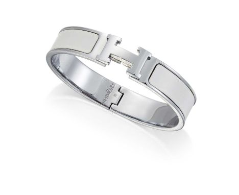 HERMÈS - A CLIC CLAC H BANGLE filled with white enamel, with 'H' clasp, marked 'Hermès R', with pouch and boxSome discolourat