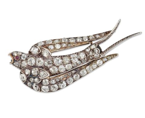 A LATE 19TH CENTURY DIAMOND SWALLOW BROOCH set throughout with old-cut and rose-cut diamonds and with a cabochon ruby eye. Es
