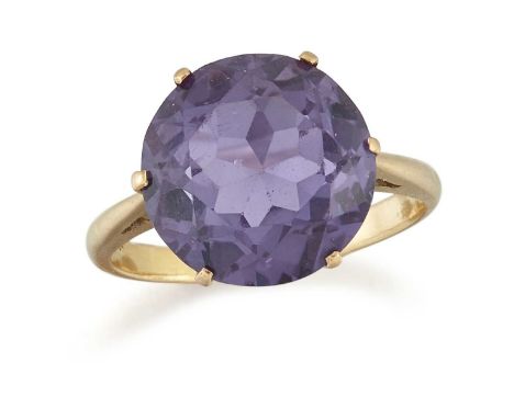 A SYNTHETIC COLOUR-CHANGE SAPPHIRE RING a round synthetic colour-change sapphire in a claw setting. Marked '22CT', ring size 