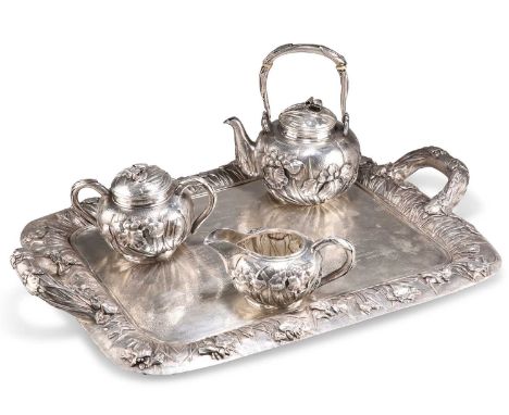 A FINE JAPANESE SILVER FOUR-PIECE TEA SERVICE X signed WATANABE, c.1900, comprising a teapot with swing-handle, sucrier, crea