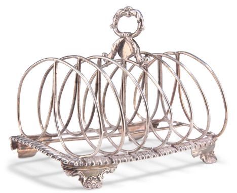 A WILLIAM IV SILVER TOAST RACK by John, Henry &amp; Charles Lias, London 1832, with seven bars, the loop handle of C-scrolls 