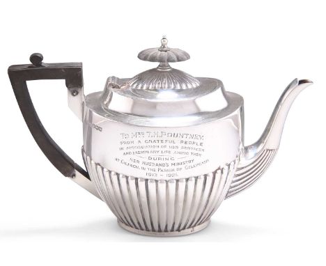 A GEORGE V SILVER TEAPOT by Walker &amp; Hall, Sheffield 1921, oval, with a partially reeded body, presentation inscription d