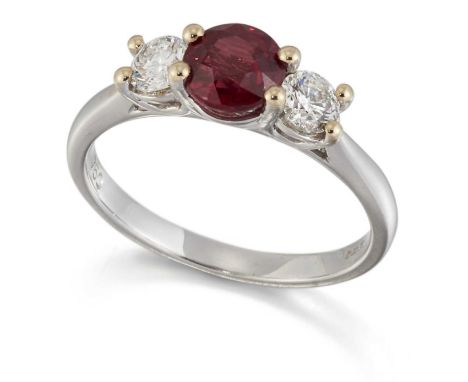 AN 18 CARAT WHITE GOLD RUBY AND DIAMOND THREE STONE RING a round-cut ruby between round brilliant-cut diamonds. Estimated tot