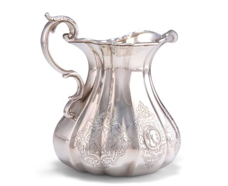 A VICTORIAN SILVER CREAM JUG by John Wilmin Figg, London 1866, broad in the beam, the fluted body engraved and with three por