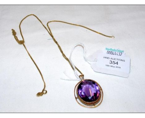 A large amethyst pendant in 9ct gold mount with chain  
