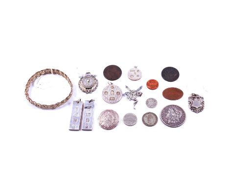 Four late 20th century silver ingots, two silver sporting fobs including one cast with footballers, a Northampton Co-operativ