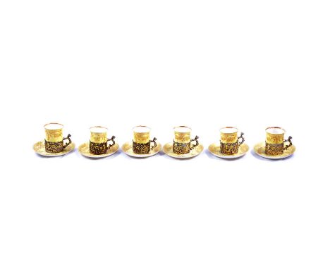 Set of six Staffordshire 'Eggshell' coffee cans held in cast silver holders, William Comyns, Birmingham 1888, with saucers, y