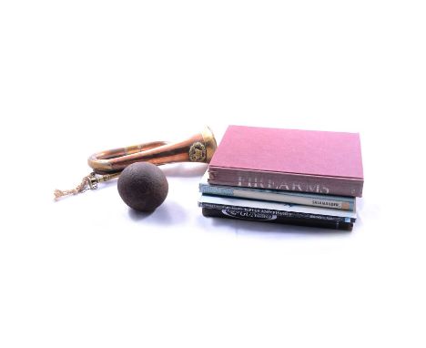Gun related books, canonball and a brass and copper bugle.Qty: 1 box