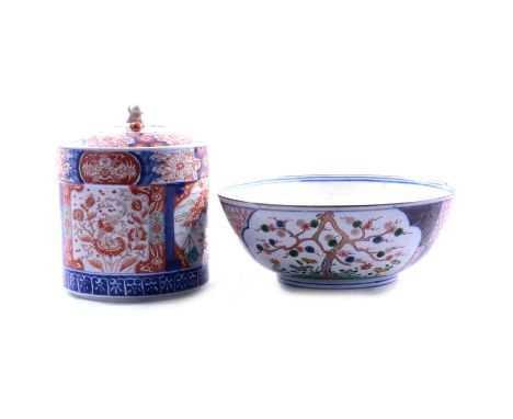 Imari cylindrical jar and cover, the cover with Fu dog finial (cover damaged), the body painted with panels of flowering gard