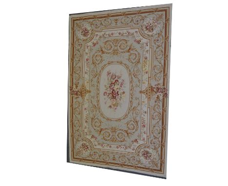 Aubusson pattern rug, champagne coloured ground with central floral motif, enclosed by Classical scrolled borders, 260cm x 16