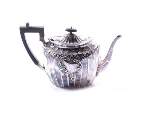A silver teapot, James Dixon &amp; Sons Ltd, Sheffield 1908, oval panelled form with scroll and foliate border, vacant cartou
