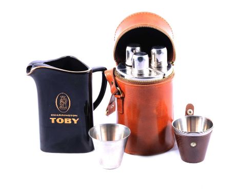 Three-bottle hunting flask, toddy cups, and a Charrington Toby whisky water jug.Condition report:Please see additional upload