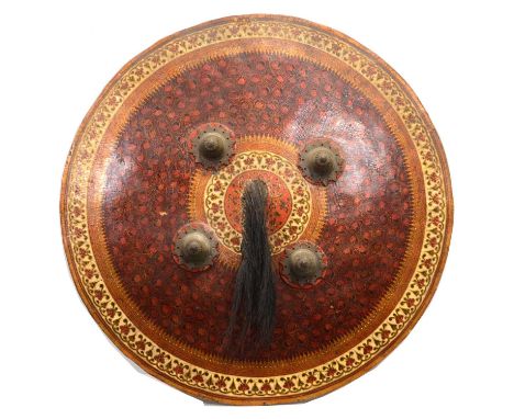 Indian dhal shield, slightly convex form, lacquered decoration with animal hair to the central roundel, with four metal bosse