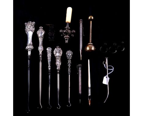 Various silver handled button hooks, a Mexican white metal rattle stamped 925, a Victorian teether with ivorine handle, a nov