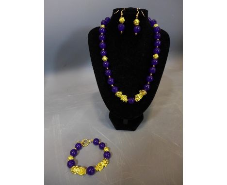 A beaded purple jade and gold plated jewellery suite, to include necklace, bracelet and earrings 