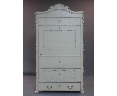 A French distressed painted cupboard, with cupboard door revealing shelves, above long drawer, having floral and shell finial