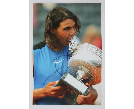 Rafael Nadal.- Autographed colour photograph, signed in black marker pen by Spanish tennis player, the winner of 22 Grand Sla