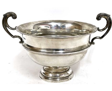 George V silver twin handled trophy cup/bowl having high scroll handles on a stepped circular base, Sheffield 1929, makers ma