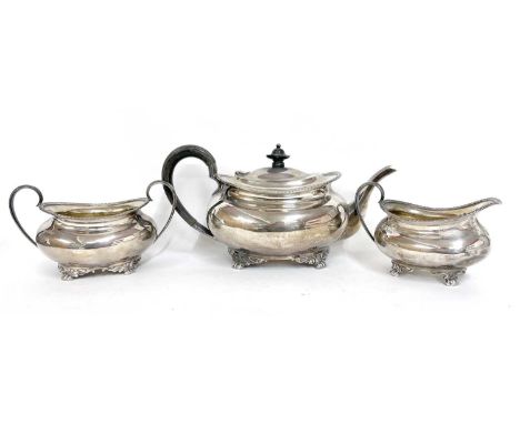 George V silver three piece tea set comprising teapot, sugar bowl and cream jug of oval form, each applied with gadrooned bor