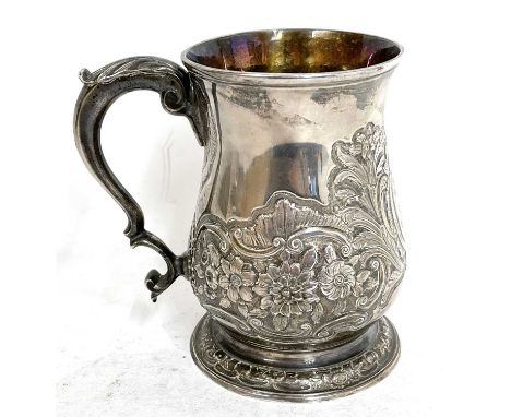 George III silver mug/tankard of baluster form to a spread circular foot with capped scroll handle and later chased floral de