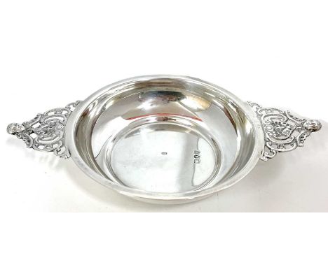 Victorian silver wine taster/two handled bowl, the plain polished shallow bowl with twin pierced figural decorated handles, h