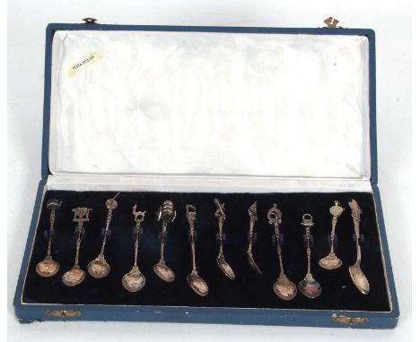 A cased set of eleven (of twelve) Spanish silver decorative coffee spoons with cast stems and finials, each finial depicting 