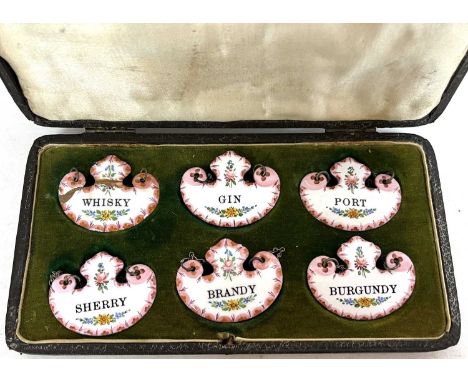 Set of six early 20th Century enamel decanter labels in fitted case (one with faults)