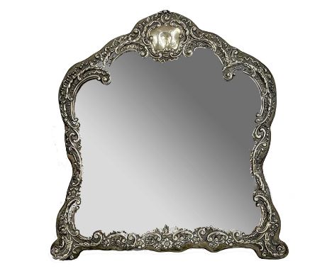 Victorian silver arch shaped framed easel backed dressing table mirror, the frame with scrolling foliage and flowers with an 