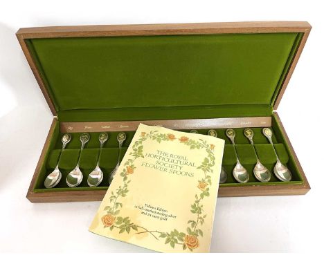 Royal Horticultural Society Flower spoons comprising 12 silver spoons each set with one of twelve gilt flowers to the termina