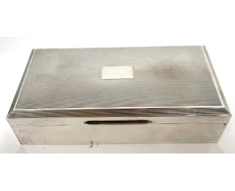 Silver cigarette box of rectangular form, the hinged lid with engine turned decoration around a plain cartouche with plain po