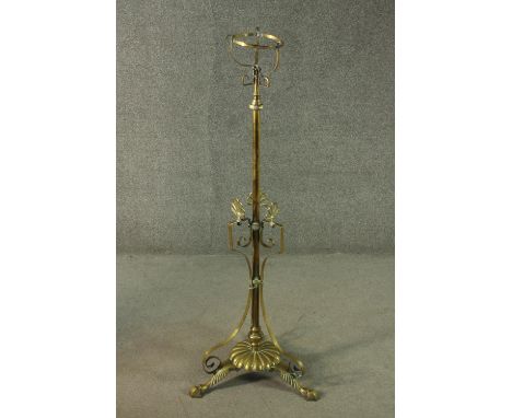 A 19th century brass extending standard stand for an oil lamp on scrolling tripod base. H.190cm (extended) 