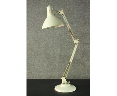 A vintage Thousand And One Lamps Ltd white anglepoise lamp, bearing label, on a circular base. H.75cm. 