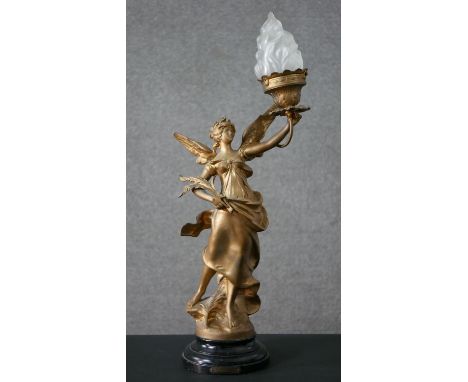 A late 19th century French “La Victoire “ gilt spelter table lamp on an ebonised base, figure has frosted glass flame shade. 