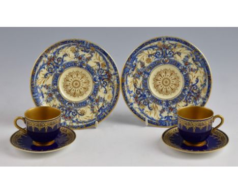 Pair of Royal Worcester cabinet cups and saucers the cups with gilded interiors decorated in cobalt blue and gilt date code f