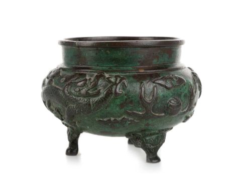 CHINESE BRONZE TRIPOD CENSER, EARLY/MID 20TH CENTURY decorated in relief with dragons chasing the flaming pearl, raised on th