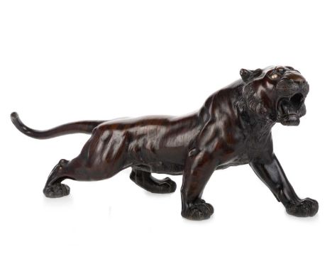 JAPANESE BRONZE TIGER, MEIJI PERIOD (1868 - 1912) modelled open mouthed on all fours, set with glass eyes, bearing signature 