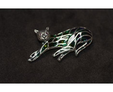 A SILVER PLIQUE A JOUR CAT BROOCH / PENDANT, set with ruby eyes