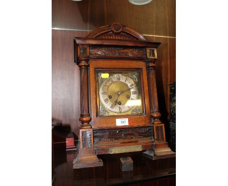 AN ANTIQUE CARVED MAHOGANY BRACKET CLOCK BY JUNGHANS, STRIKING ON BARS, A/F