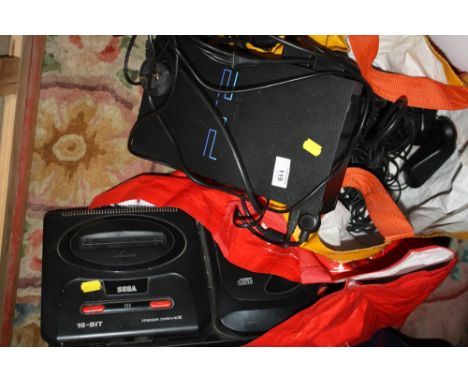 A SEGA MEGA DRIVE 2 CONSOLE WITH MEGA CD 2 ATTACHMENT TOGETHER WITH A PS2 CONSOLE AND CONTROLLERS