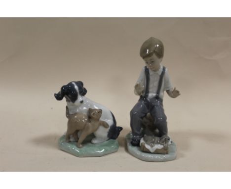 A NAO FIGURE OF A DOG AND A CAT TOGETHER WITH A NAO FIGURE OF A BOY WITH A PUPPY