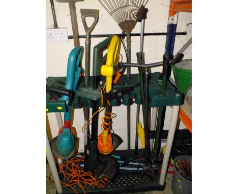 A PLASTIC GARDEN TOOL STAND PLUS GARDENING TOOLS