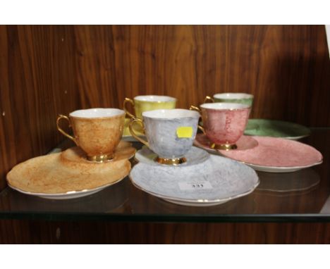 A SET OF FIVE HARLEQUIN COLOURED ROYAL ALBERT GOSSAMER CUPS AND SERVING SAUCERS