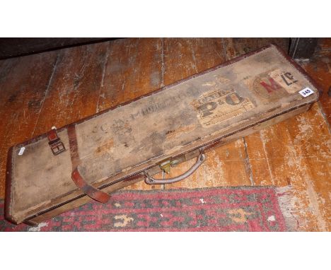 Old Edwardian canvas covered rifle or gun case, with luggage labels to exterior, leather bound with contents, cleaning rods e