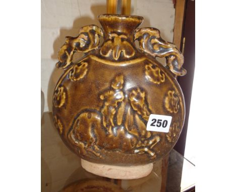 Chinese moon flask with raised horse and rider decoration, in brown treacle glaze