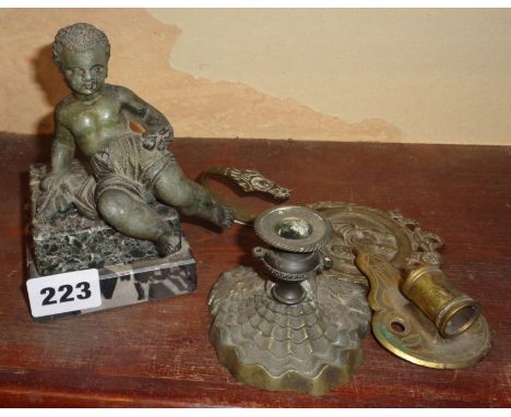 Putti figure set on marble plinth, an ornate brass tie-back and two other brass items