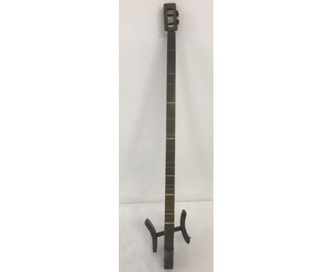 A vintage ethnic 2 stringed instrument with leg rests.  Approx. 78cm long.