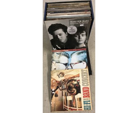 A vintage blue record case containing a quantity of vinyl LP's. To include; Foreigner, Megadeath, Meat Loaf and The Proclaime