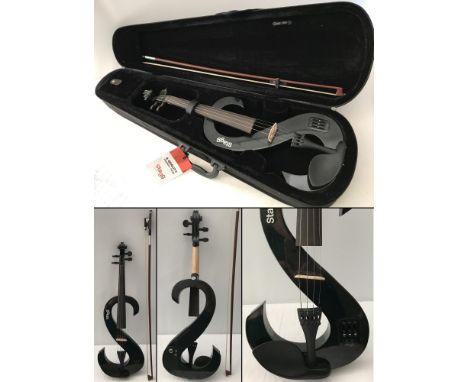 A cased Stagg S shaped electric violin. Complete with bow. Metallic graphite grey paint finish to body. Wood bridge and neck.